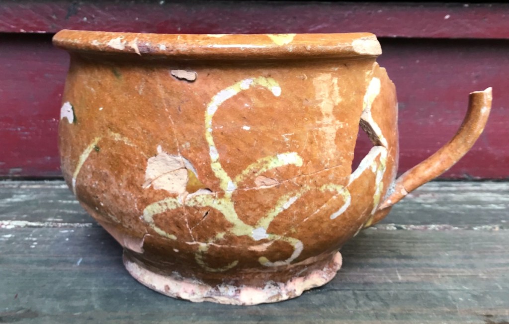 Slip-decorated chamber pot attributed to the Daniel Bayley Pottery Company. Recovered in Eighteenth Century contexts in Portsmouth, N.H. Courtesy Strawbery Banke archaeology department.