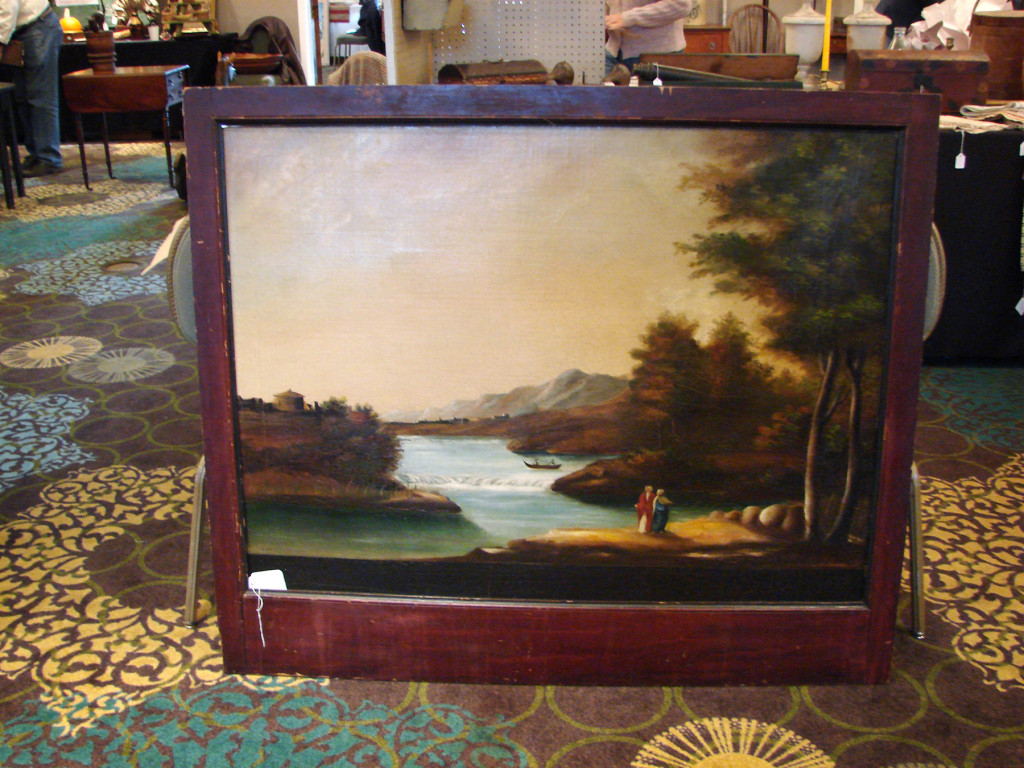 Bob Jessen and Jim Hohnwald, Fitzwilliam, N.H., offered this fireboard that had been reframed for easy hanging. The landscape with a river, small boat, two well-dressed people on shore and more was priced at $2,500. The dealers believed it dated to the late 1800s.