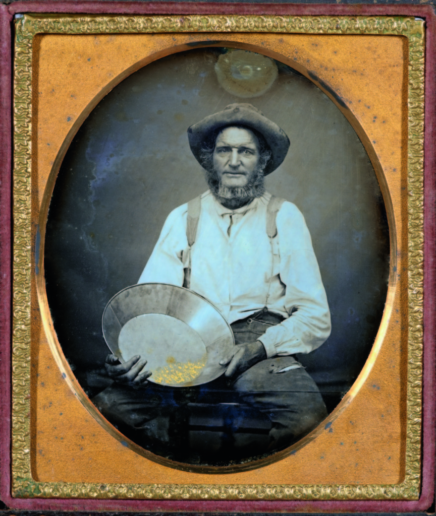 “Portrait of miner holding pan with gold” by unknown maker, circa 1852. Daguerreotype, sixth plate, 3¼ by 2¾ inches.   —Gift of the Hall Family Foundation.
