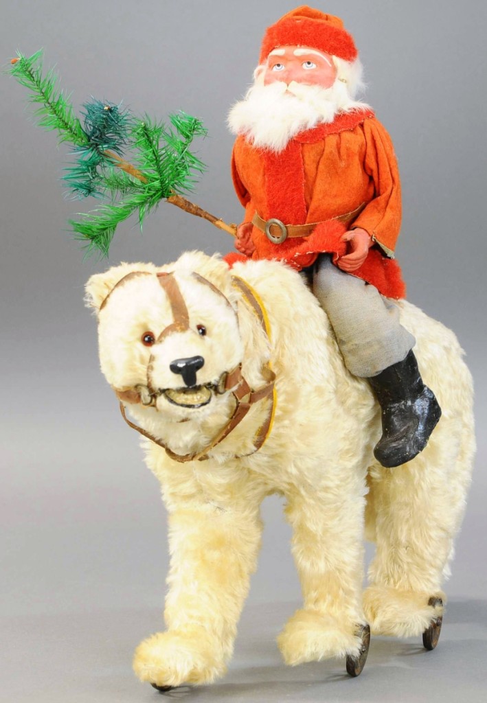 Santa On Polar Bear Growler Toy, with a rabbit fur beard on his composition face and wearing a red waistcoat with red fur trim, sits atop a large creamy white polar bear with brown glass eyes and sporting a leather harness. He moves his head as he rolls along on iron wheels. His growler mechanism no longer works and Santa’s boots have small touch ups. In very good condition, this toy at 22 inches in length carried a high estimate of $4,000, but sold for $43,200.