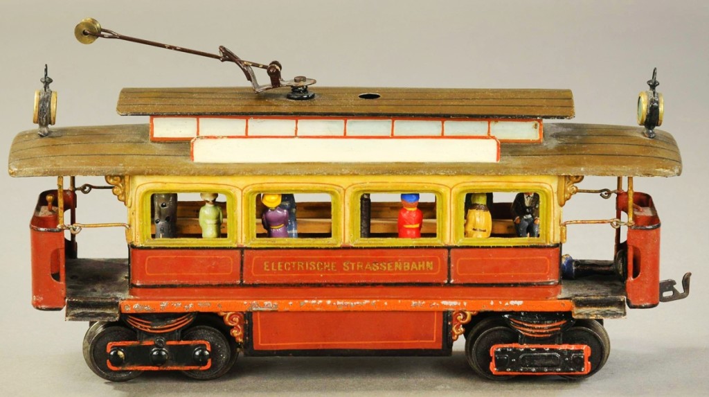 Marklin Electrische Strassenbahn, another gauge 1 clockwork trolley, circa 1904, has four original passengers and end ramp signs. It has a replaced conductor pole and headlights, sidebar and roof reattached with minor touchups on sides and is 12 inches long. Listed in very good condition, it brought $21,600.