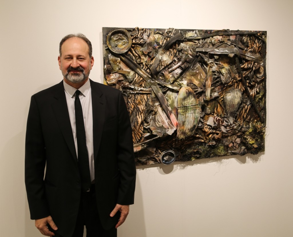 Fair owner Andrew Edlin stands next to “Working at Home,” a circa 2000 work by Thornton Dial that had just sold. Andrew Edlin Gallery, New York City.