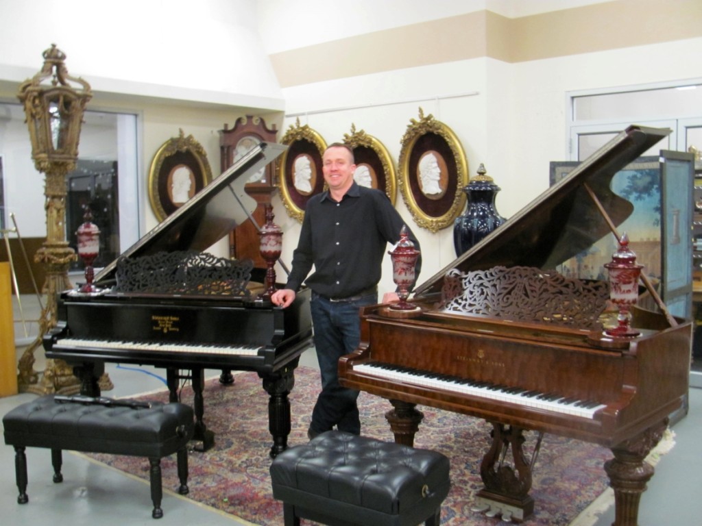 “We had a lot of questions about them,” said Eddie Nadeau, shown here between two grand pianos from the Greenwich, Conn., estate of Deborah Black, that were each estimated at $10/20,000 and realized, from left to right, $28,060 and $19,520. Two American phone bidders won them.