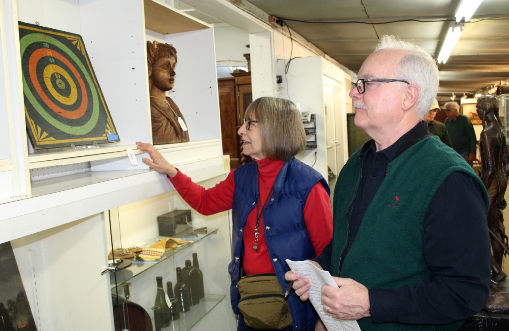 Joanne and Brian Kaley, proprietors of Cobblestone Antiques in Pleasant Valley, N.Y., were looking at items during the morning preview before the sale started on New Year’s Day.