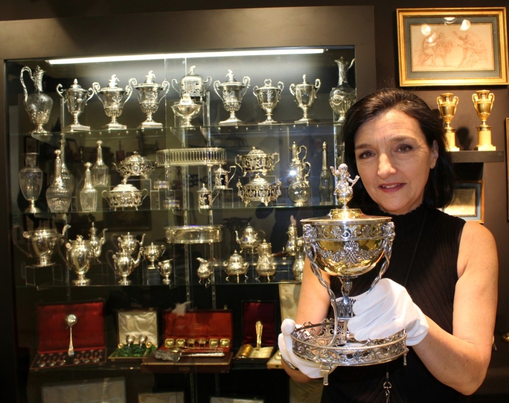 Jasmine Doussière of Silver Art by D&R, Marseille, France, and New York City, holds a rare antique silver and vermeil sugar bowl, or ceremonial sugar bowl, 1810, by Maitre Orfèvre Pierre Bourguignon.  Decorated in the Louis XVI style, the piece features a vine garland with three Pan heads, associated with wine and gaiety, and the lid is surmounted by a cupid as a floret.  “It was a good show for us,” said Doussier.  “We saw a constant flow of customers over the three days.