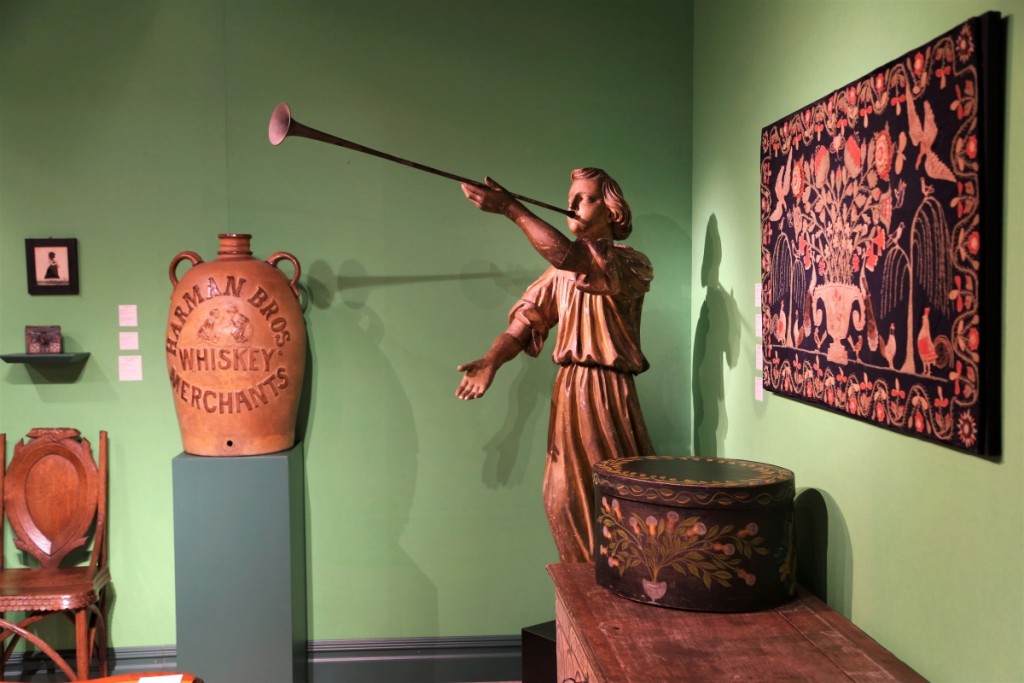 West Virginia stoneware cooler made by A.P. Donaghho & Son of Parkersburg, W.V., and advertising Harman Brothers Whiskey Merchants of Staunton, Va., left. The carved Gabriel angel is possibly from New York State and dates to about 1890. Kelly Kinzle, New Oxford, Penn.