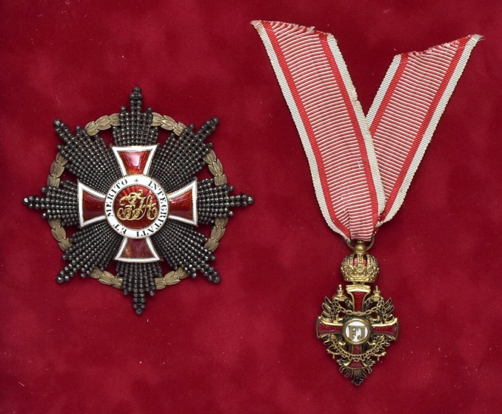 Order of Franz Joseph Knights Cross, 2-inch-long gilt bronze with enamel with original box and Order of Leopold Grand Cross with red and white enamel, 3¼-inch-long Austrian medals, both now framed in a shadow box sold at $9,000.