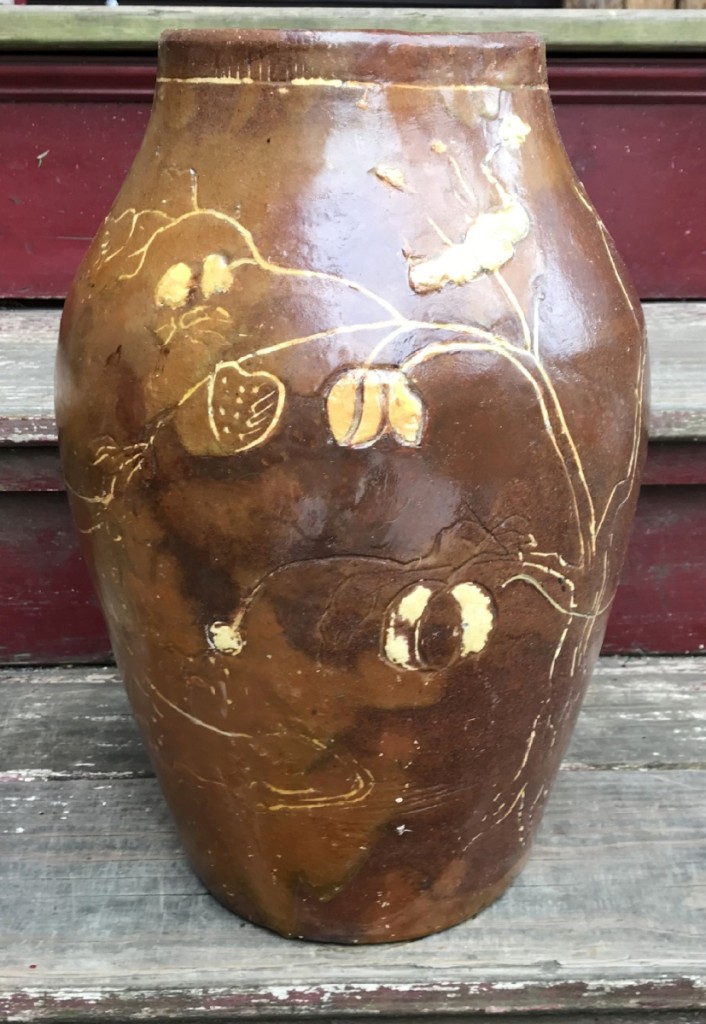 Another view of the jar decorated with flowers, eagles and a peacock.
