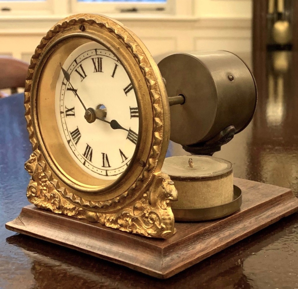 Seen here is a night clock by the British United Clock Co., Ltd.,   Birmingham, England, 1853. A candle would sit behind   and light the face through the darkness.