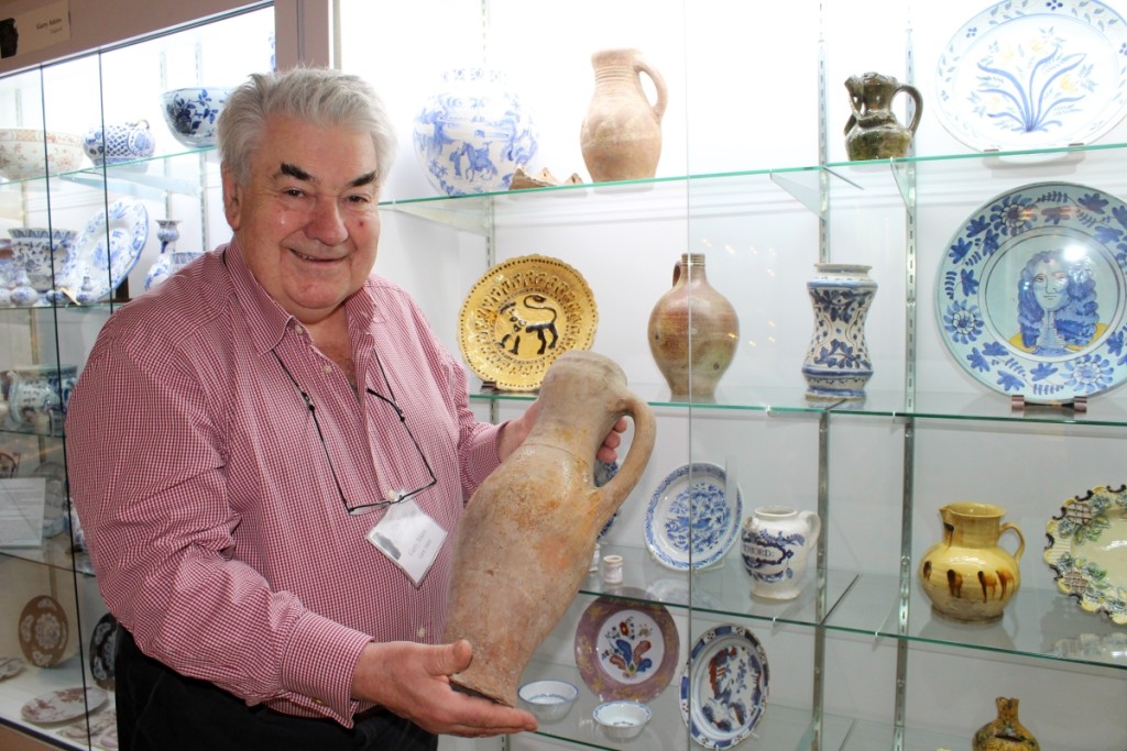 Garry Atkins with a Thirteenth Century tall vase. “It’s amazing that it’s so old but has no damage,” said the dealer as he carefully removed it from the shelf. It sold to Rob Hunter.