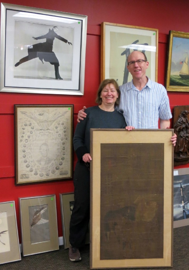 Rosie and Jack DeStories stand in front of the Chinese painting and Richard Avedon photograph that tied for top lot, each bringing $9,600.