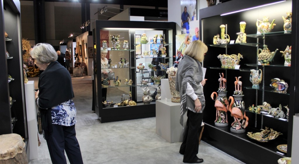 Showgoers admiring the selection of South African Ardmore Ceramic art with Pacoe Gallery, North Miami, Fla.