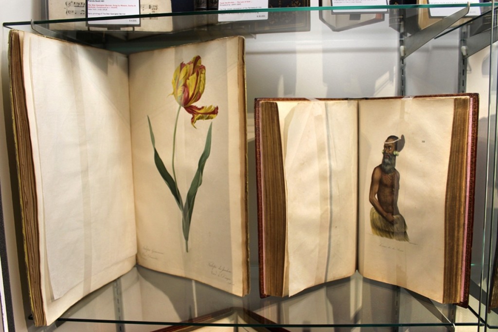 Two rare tomes on offer at Donald Heald Rare Books, New York City — left, the 1824 album of botanicals by Pierre Joseph Redoute and a fundamental hand-colored work by Louis Choris on Alaska, California and Hawaii, characterized as “one of the most beautiful books of travel in existence.”