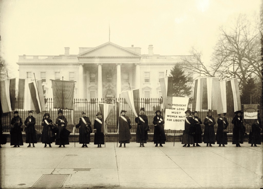 The Silent Sentinels were the first group to demonstrate at this strategic location. Women Suffrage Pickets at the White House, 1917.   Harris & Ewing Photograph Collection, Library of Congress.