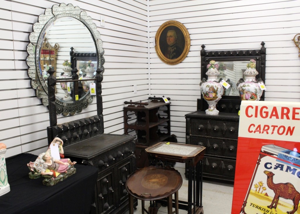 “People liked the tramp art,” Corcoran said, who had several pieces in the sale, all from a collection in Harlem, N.Y. A tramp art dresser with towel rack (left), brought $390, while a similar dresser with mirror back that was offered immediately after (right) realized $450. The oval portrait on the wall made $210, slightly more than its high estimate.