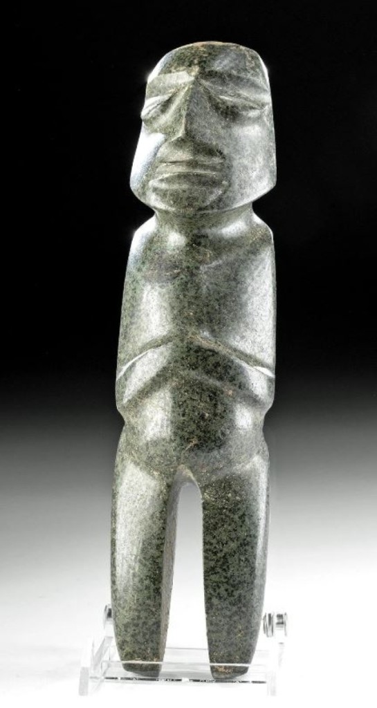 This Mezcala axe-god figure dates from 500 to 200 BCE and is hand carved from mottled grey-green diorite with black inclusions. M-26 type. It hails from the Guerrero region of Southern Mexico and sold for $21,165 over a $5,000 estimate. 9-  inches high.