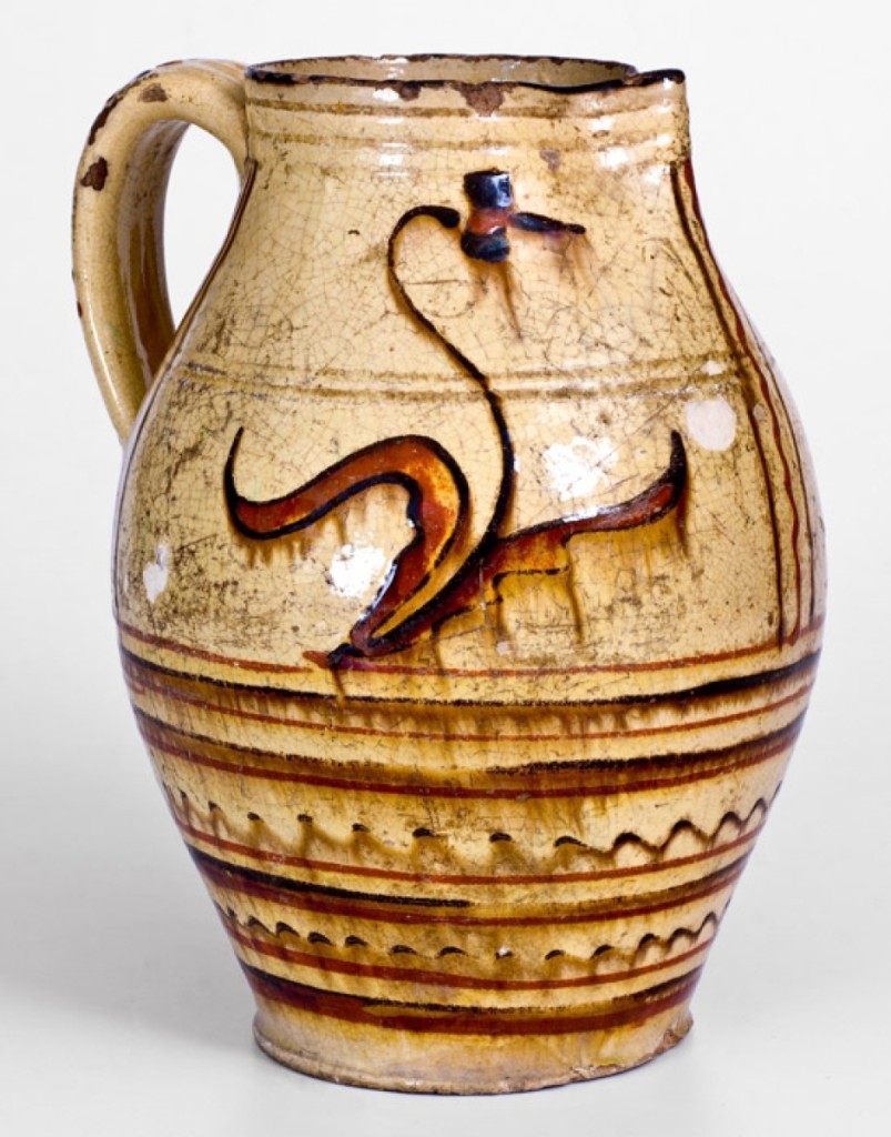This Alamance County redware pitcher featured a great decorated handle and a nicely done floral motif to the body. It sold for $33,600, and the auction house attributed it to the Loy or Albright families.