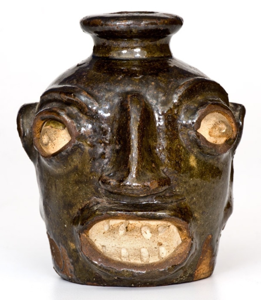 A Miles Mill (attributed) alkaline-glazed stoneware face jug with kaolin eyes and teeth went out at $31,200. It measures 5 inches high.