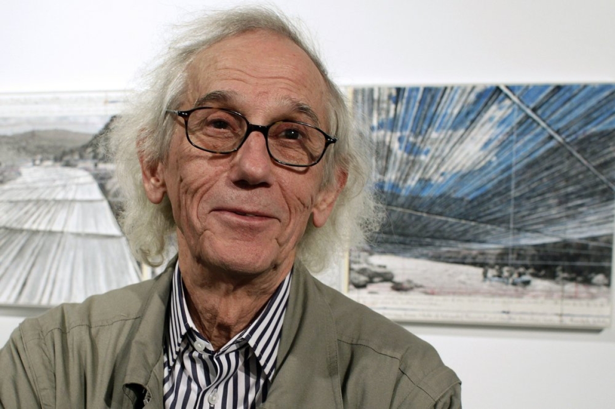 This January 23, 2013, file photo shows artist Christo posing in front of his proposed “Over the River” project at the Metropolitan State University Center for Visual Art in Denver. AP Photo/Brennan Linsley.