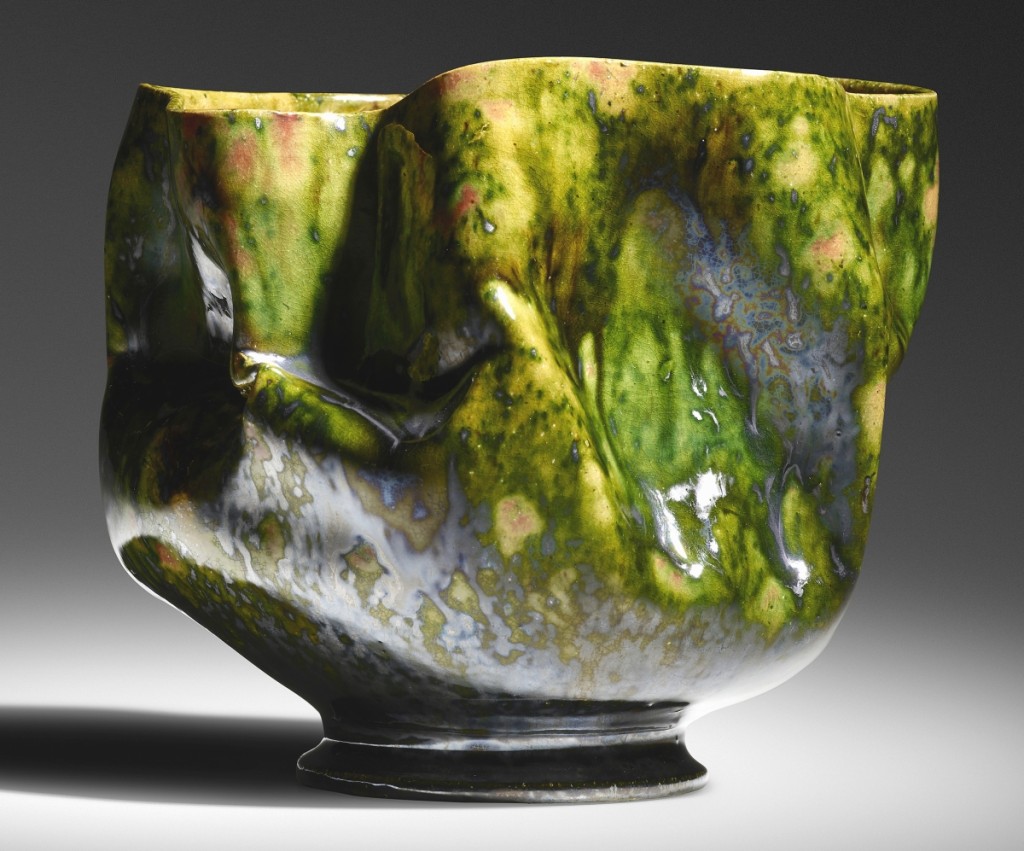 From an extensive run of pieces by the “Mad Potter of Biloxi” George Ohr, the top selling piece, at $62,500, went to this large vase, 1897-1900, 5½ inches high by 6½ inches wide, featuring Ohr’s trademark in-body manipulations and sporting green, gunmetal and raspberry glazes with a yellow interior.