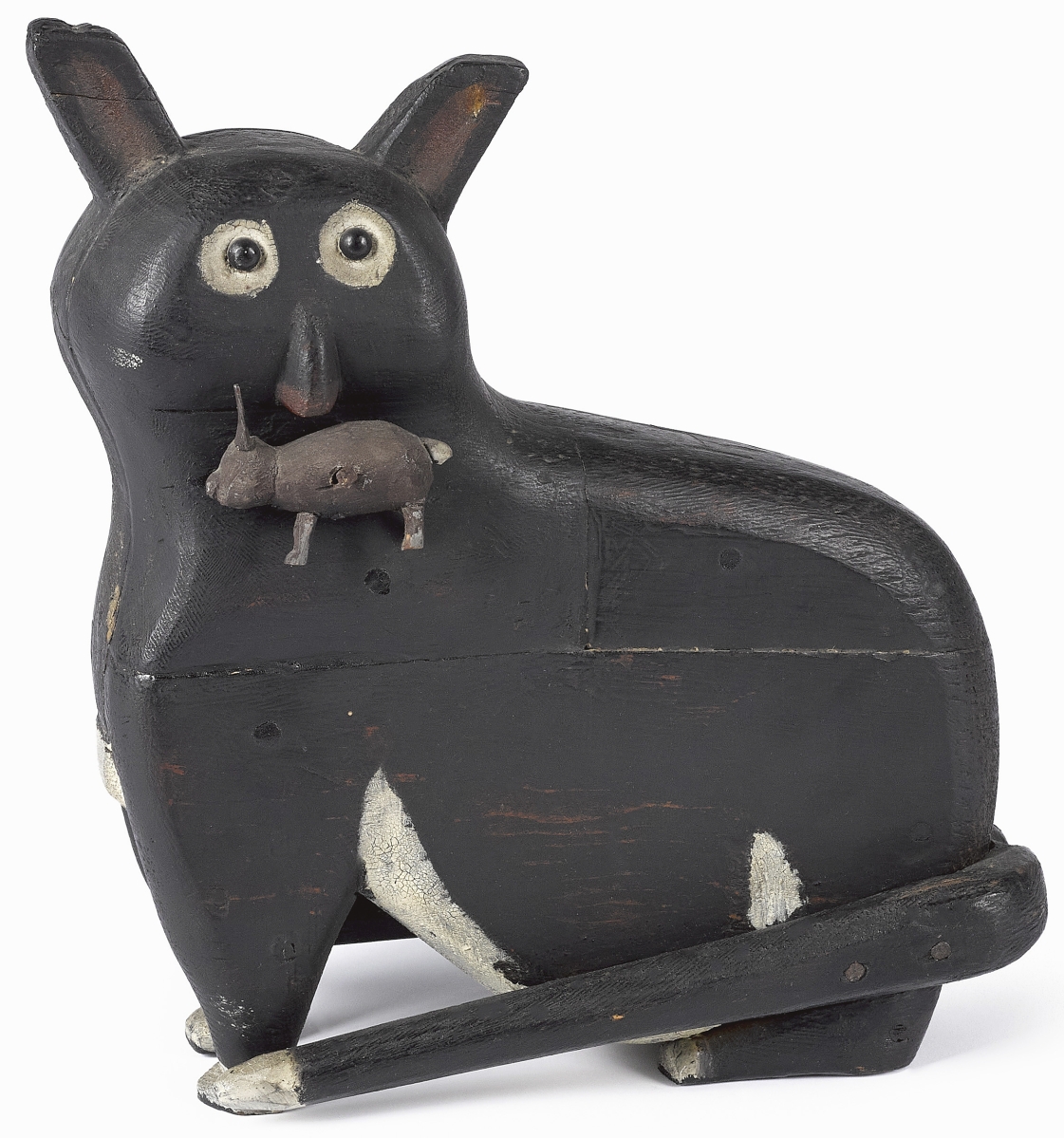 The look on this carved and painted cat — his wide eyes and bent ears — endeared it to near anyone who has ever owned a cat and dealt with their hunting behaviors before. It suggests the moment the cat is spotted by its owner having gotten yet another rabbit, seen hanging from its mouth, from the farmer’s pen: a look of getting caught. Bidders fell for it when the 11½-inch example sold for $26,840. It was exhibited at the Historical Society of Berks County in 1991 and featured in Machmer’s Just For Nice.