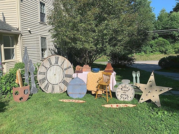 Jeff Pudlinski of County Seat Antiques (@county_seat_antiques), Litchfield, Conn., offered a variety of painted wall hangings. A number of sales were logged from this picture, including a red wall box, the large clock hands, two textiles and the large wooden clock face. The pie board seen at center is in original blue paint. 