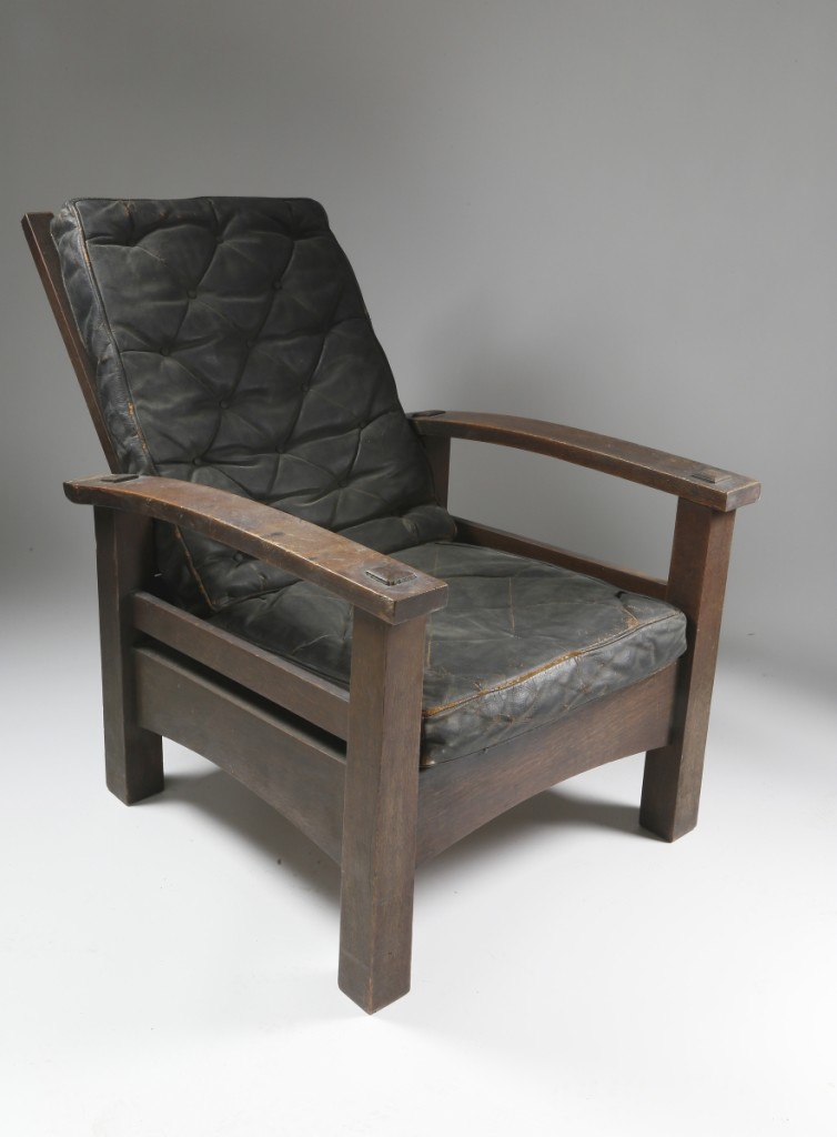 From the estate of Nantucket resident and conservationist Linda Loring, this Gustav Stickley reverse tapered bow-arm Morris chair, circa 1901, in oak with original black leather upholstered seat back and cushion, was bid to $48,800.