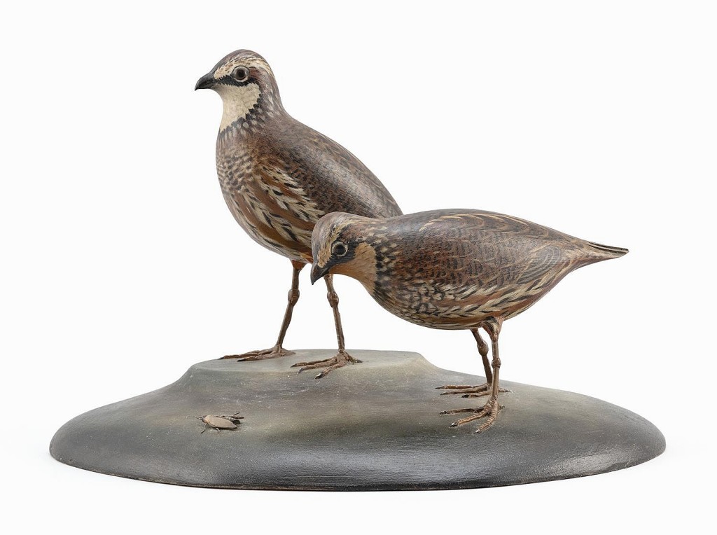 From the Mr & Mrs Kenneth DeLong collection of bird carvings, a rare pair of A. Elmer Crowell decorative life-size bobwhite quail, circa 1938, went out at $25,000. Details include one quail looking at a carved fly on the base.