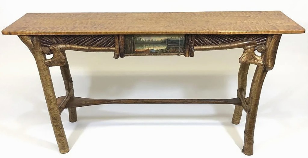 Contemporary furniture maker and artist Barney Bellinger’s highest lot in the sale was this sofa table, which sold for $8,625. It had a maple top, canoe paddle stretcher and mosaic skirt, with a central painting of a lean-to at Cedar Lakes.