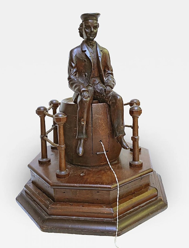 The only marked sale for Heller Washam, Portland, Maine, was a good one: this 19-inch-high figural string jack in the form of a Jack-Tar sailor or ship rigger sitting atop an upturned barrel. The dealer said it dated to the first half of the Nineteenth Century. It had a label on the bottom for “W.H. Brickett, Dealer in Clocks, No. 2 Bromfield Street, Corner of Washington (Boston).”