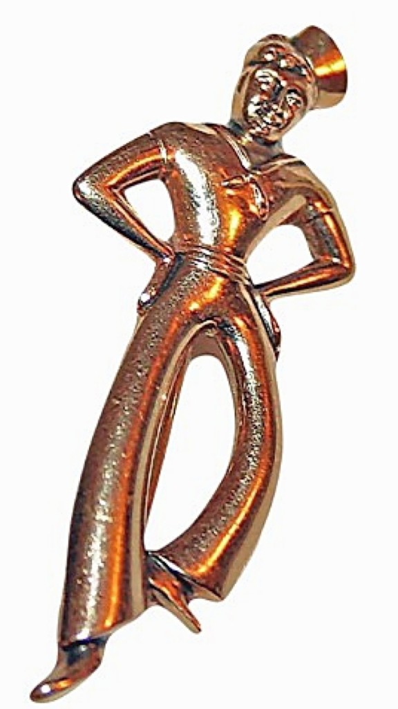 Home Farm Antiques, Bolton Landing, N.Y., sold this World War II-era Deco brooch of a dancing sailor in 10K yellow gold. It was marked Forstner. It was one of five sales at the show, including a World War I-era child’s armistice dress, a vintage 1970s suede cowgirl suit, a box of violet corsages and a copper kettle.