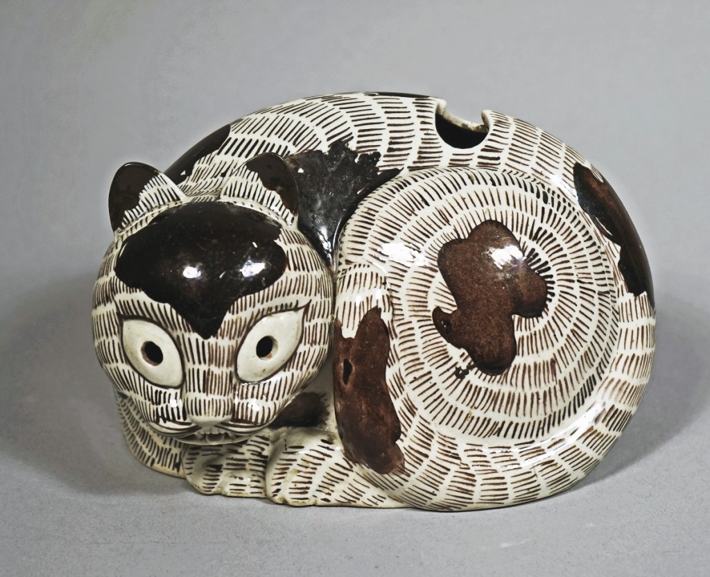 Sepia and aubergine glazed porcelain cat night lamp, China, Kangxi period, AD 1662-1722. Ralph M. Chait Galleries.