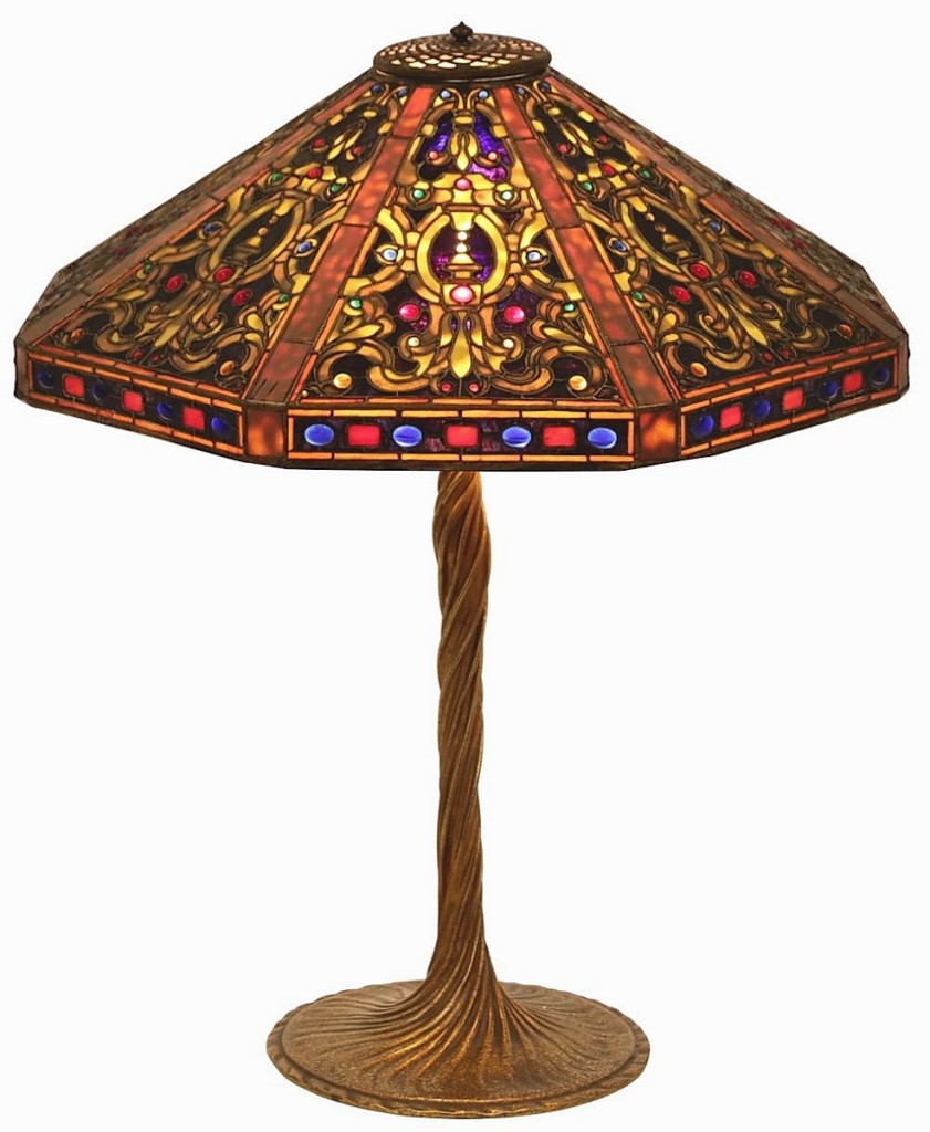 The top four lots of the sale were Tiffany lamps. At $90,750, the second highest price of the auction, was a 22-inch octagonal Elizabethan example with red, green, amber and blue jewels set in yellow-green arabesques. It was signed on both shade and base.