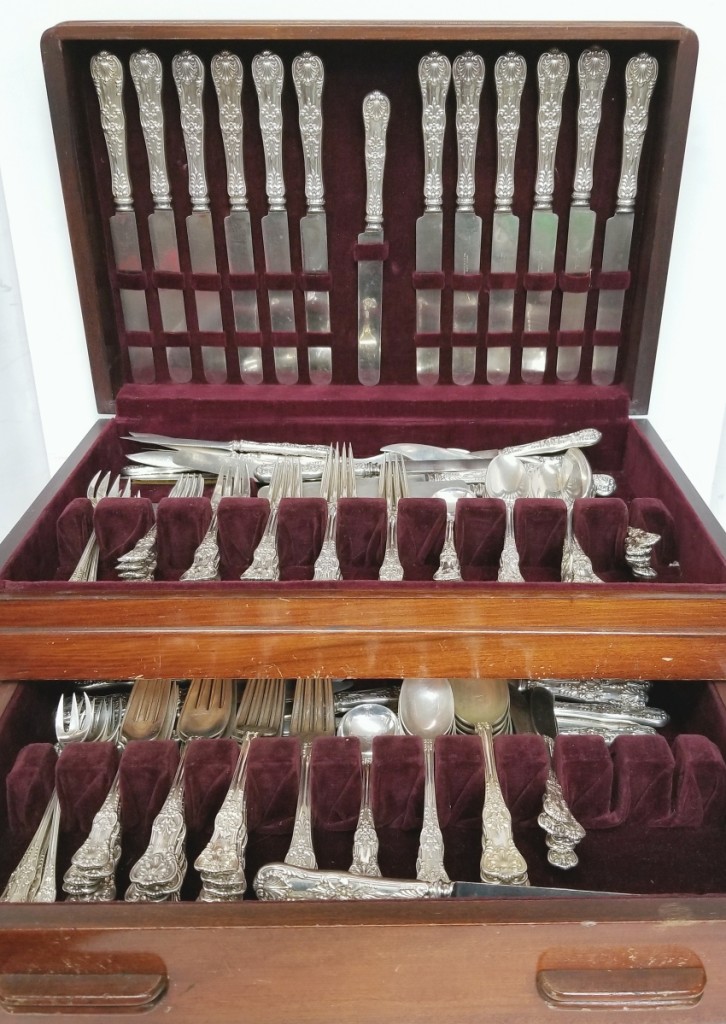An antique Tiffany & Co sterling silver 152-piece English King flatware service fitted inside a chest set the place at $6,490.