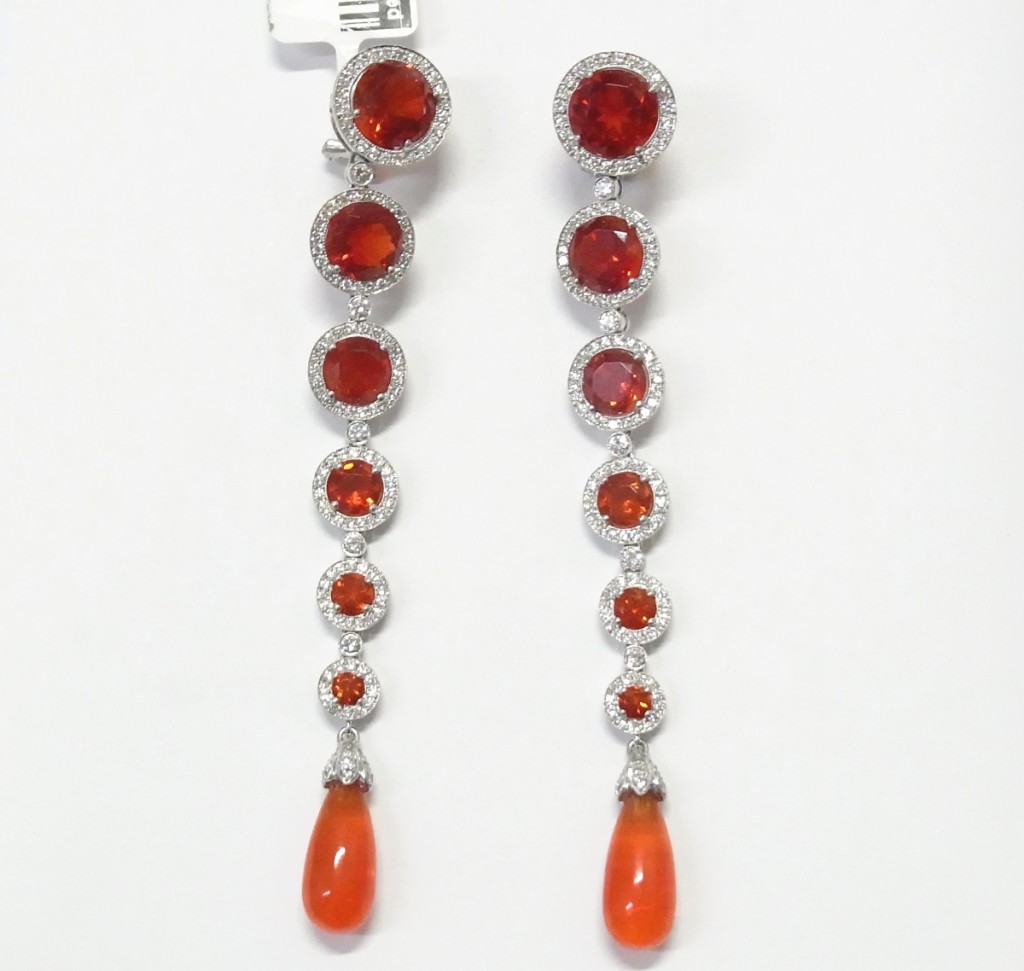 Selling for $14,760 was this rare pair of Tiffany & Co. 32-carat Cherry Fire opal 2.50 carat weight diamond extra-long platinum dangle earrings.