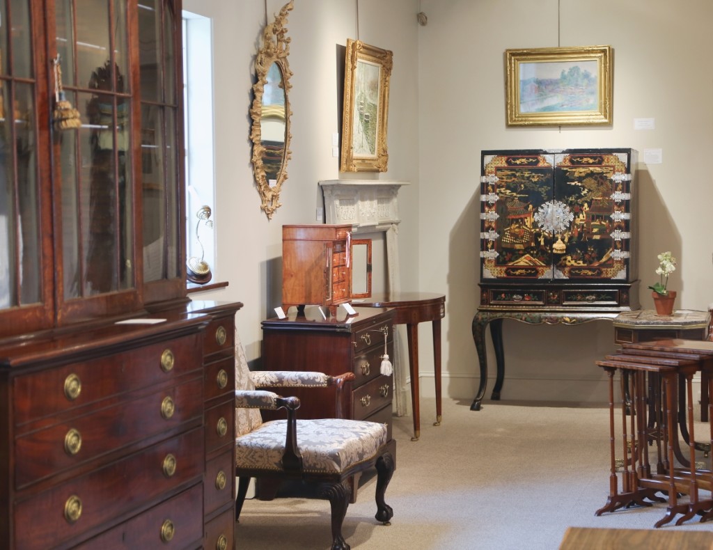 A European, likely German, lacquered chest on cabriole stand is seen on the back wall amid other fine Continental furnishings.