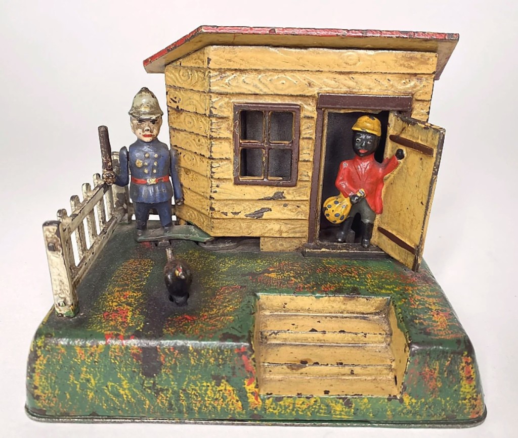 Kyser & Rex’s Uncle Remus cast iron mechanical bank went out at $7,680. The bank was in all original paint with a complete and unrestored fence.