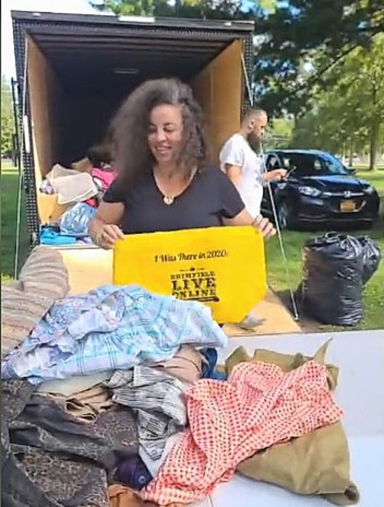 Klia Ververidis Crisafulli filling the yellow bags with clothing. She fills it until someone bids $20, winning the bag. She filled 55 bags on Saturday.