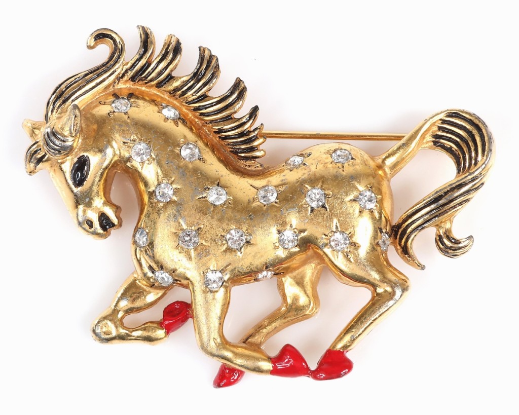 A gold-plated prancing horse with incised stars and rhinestone centers took $1,500 on a $500 estimate. It dated to the late 1930s.