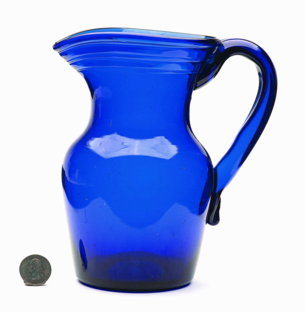 A beautiful piece of early American tableware with a gracefully formed handle and vivid cobalt blue color, this free-blown pitcher, possibly Pittsburgh, 1820-40, realized $3,218.