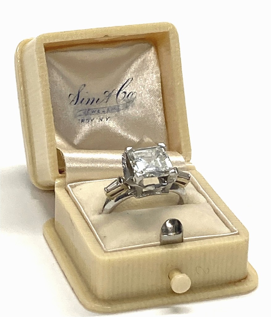 A 3.12-carat Asscher cut diamond set with two baguettes in platinum took $16,800.