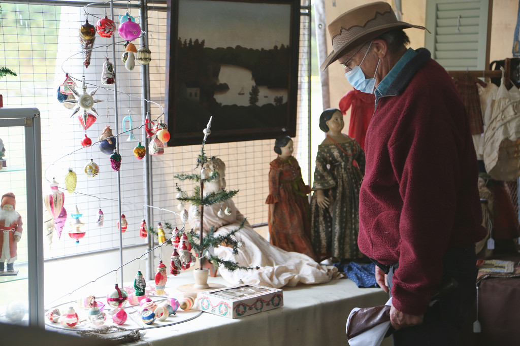 A buyer looks through the assortment of Christmas ornaments at Blue Dog Antiques, Stafford Springs, Conn. —Black River Antique Show