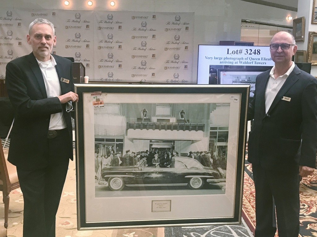 One of the most expensive items in the sale was this 51-by-45-inch photo of Queen Elizabeth II and Prince Philip arriving at the hotel in 1957, which sold for $40,000. Frank Kaminski is on the right and Cliff Schorer is on the left.