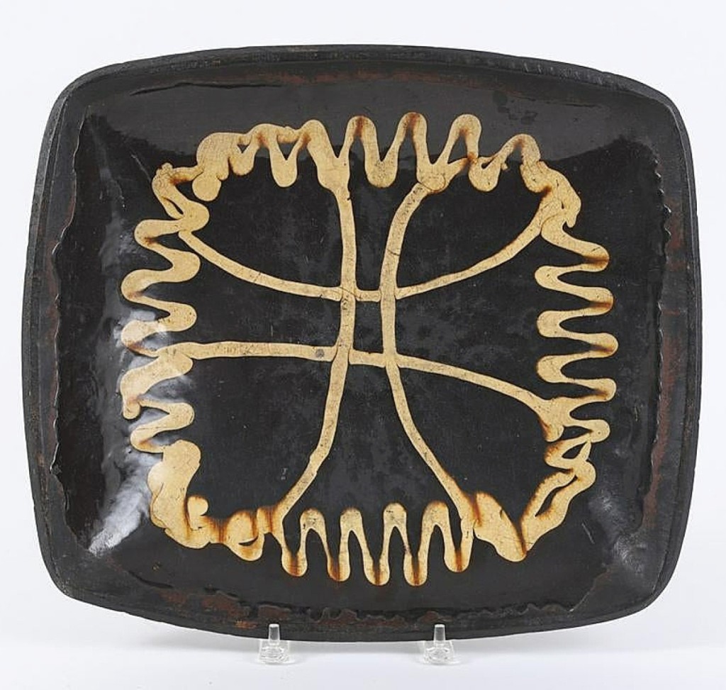 There was not much redware in the sale. At $12,000, this 15-by-17-inch slip-decorated redware tray, which Bonney bought from Gary Adkins, was the highest price ceramic item in the auction.