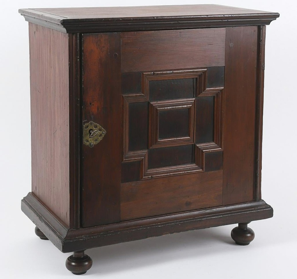 The second highest price of the day, $25,000, was earned by this 1670-1700 Massachusetts joined oak spice cabinet on ball feet, with a paneled door, several drawers and original butterfly hinges.