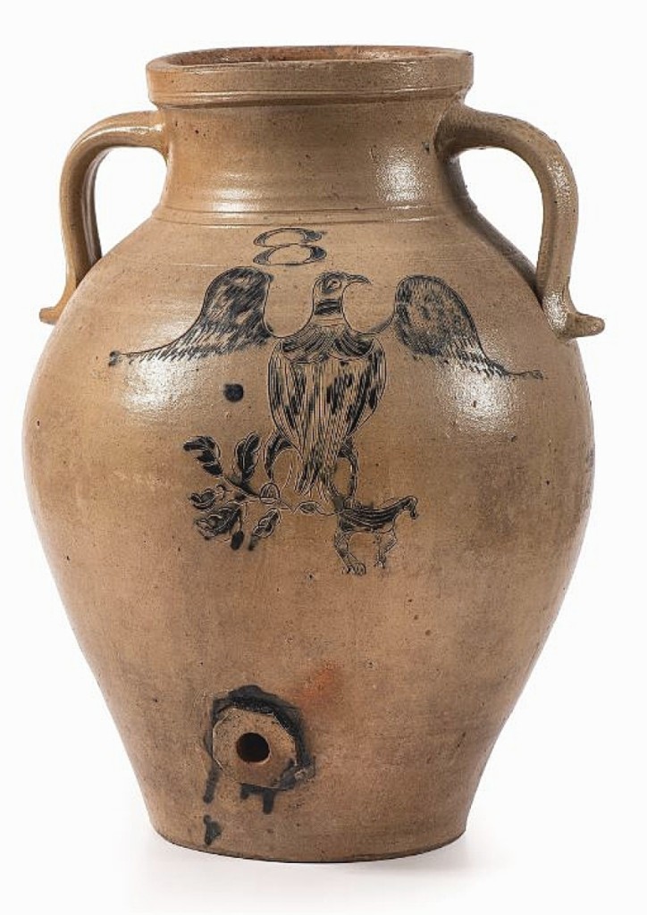 Highest among all stoneware lots in the Hahn sale was this Ohio stoneware water cooler with incised and cobalt decorated Federal eagle. It sold for $11,875. The eagle clutches a leafy branch in one claw and a dog in the other.