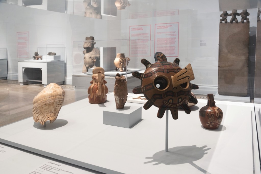 Seen at front right is a funerary mask by an unknown Paracas Cavernas artist, possibly collected on the South Coast of Peru, 300 BCE-1. Ceramic, resin, and pigments. Brooklyn Museum. Frank L. Babbott Fund and Dick S. Ramsay Fund. Photo Jonathan Dorado.
