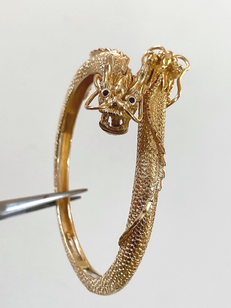 Fetching $2,688 was this 18K gold dragon hinged cuff bracelet.