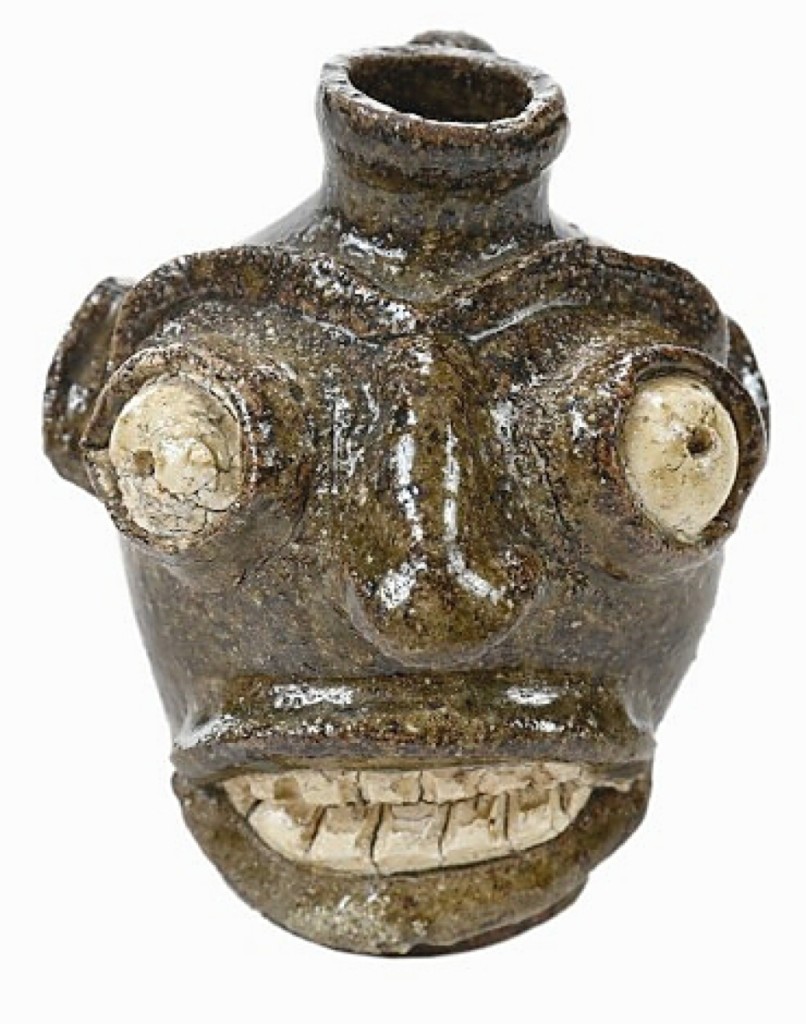 This face jug, made between 1860 and 1880 in the Edgefield District of S.C., was just 3½ inches tall. Possibly made at the Davies Pottery, it was rare and brought a commensurately high price, selling to an American private collector on the phone for $47,880. Wingard collection. ($15/25,000).
