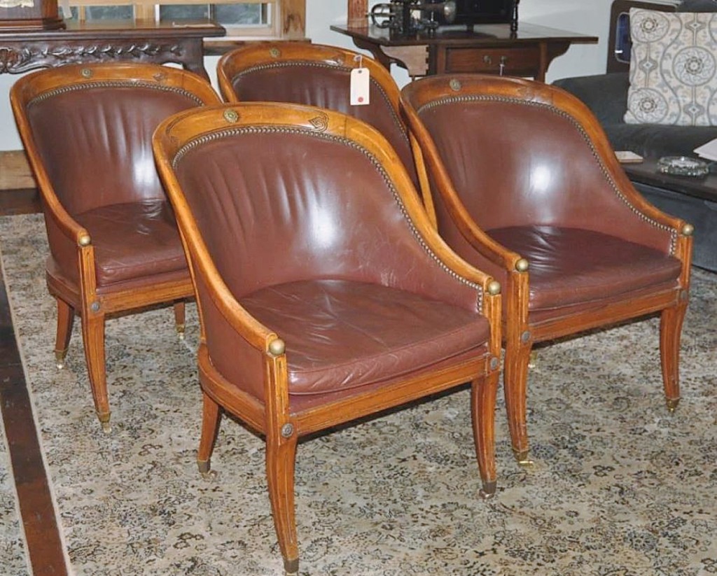 On sabre legs and accented with brass medallions, this set of four walnut tub chairs sold for $4,270.